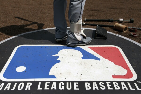 FILE - A player stands on the Major League Baseball logo that serves as the on deck circle during the first inning of a baseball game between the Chicago White Sox and Cleveland Indians in Chicago, April 24, 2013. There was just one positive test resulting in discipline from among a record 11,783 samples collected by Major League Baseball and the players鈥� association in the year ending with the 2023 World Series. Therapeutic use exemptions for attention deficit hyperactivity disorder dropped for the 10th straight year. There were 61 exemptions, independent program administrator Thomas M. Martin said Friday, Dec. 1, 2023, in his annual report.(AP Photo/Charles Rex Arbogast, File)