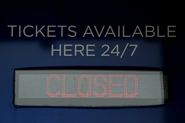 Ticket windows are closed at Kauffman Stadium, home of the Kansas City Royals baseball team, Wednesday, March 25, 2020, in Kansas City, Mo. The start of the regular season, which was set to start on Thursday, is on hold indefinitely because of the coronavirus pandemic. (AP Photo/Charlie Riedel)