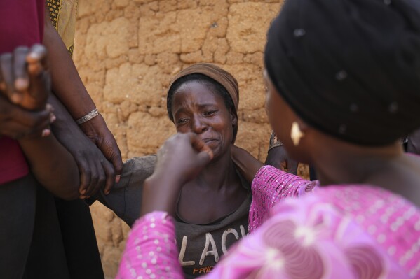 Women mourn the death of a family member following an attack by gunmen in the Zike farming community in north-central Nigeria, April 15, 2025. (AP Photo/Samson Omale)