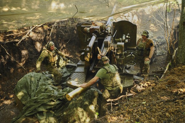In this photo provided by Ukraine's 127th Separate Brigade of the Territorial Defence press service, soldiers fire a canon towards Russian army positions near Kharkiv, Ukraine, Monday, June 2, 2025, (Anatolii Lysianskyi/Ukraine's 127th Separate Brigade via AP)