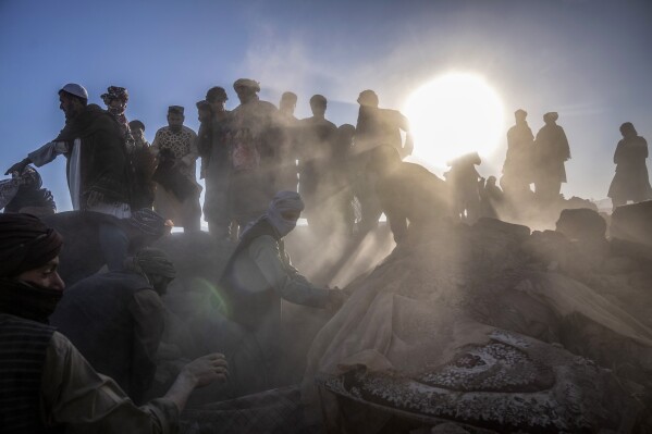 Afghan men search for victims after an earthquake in Zenda Jan district in Herat province, of western Afghanistan, Monday, Oct. 9, 2023. Saturday's deadly earthquake killed and injured thousands when it leveled an untold number of homes in Herat province. (AP Photo/Ebrahim Noroozi)