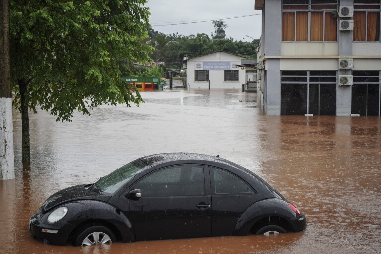 Streets are flooded after heavy rains in São Sebastião do Cai, Rio Grande do Sul state, Brazil, Thursday, May 2, 2024. (AP Photo/Carlos Macedo)