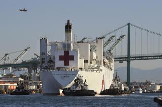 FILE - The USNS Mercy hospital ship enters the Port of Los Angeles, March 27, 2020. The Solomon Islands government on Wednesday, Aug. 31, 2022, asked countries to not send naval vessels to the South Pacific nation until approval processes are overhauled. The U.S. Navy hospital ship USNS Mercy is currently in Honiara. (AP Photo/Mark J. Terrill, File)