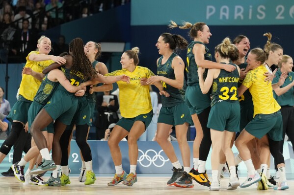Australia celebrates after a women's bronze medal basketball game at Bercy Arena at the 2024 Summer Olympics, Sunday, Aug. 11, 2024, in Paris, France. (AP Photo/Mark J. Terrill)