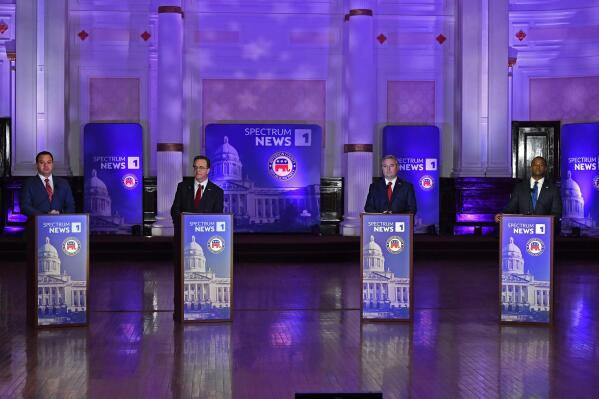 From left, Somerset, Ky., Mayor Alan Keck, Kentucky State Auditor Mike Harmon, Kentucky Agricultural Commissioner Ryan Quarles and Kentucky Attorney General Daniel Cameron prepare for the start of the Kentucky Gubernatorial GOP Primary Debate in Louisville, Ky., Tuesday, March 7, 2023. (AP Photo/Timothy D. Easley, Pool)