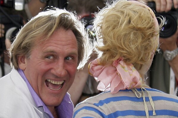 French actor Gerard Depardieu, left, and Belgian actress Cecile de France pose during a photo call for the film "Quand J'etais Chanteur," at the 59th International film festival in Cannes, southern France, on May 26, 2006. (AP Photo/Francois Mori, File)