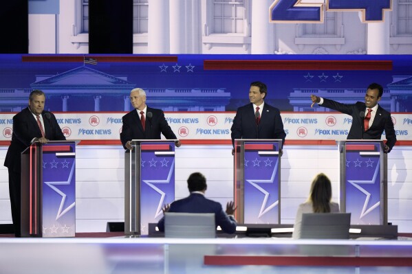 Businessman Vivek Ramaswamy, Florida Gov. Ron DeSantis and former Vice President Mike Pence look toward former New Jersey Gov. Chris Christie during a Republican presidential primary debate hosted by FOX News Channel Wednesday, Aug. 23, 2023, in Milwaukee. (AP Photo/Morry Gash)