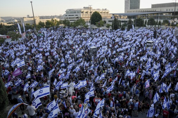 Israelis protest against Prime Minister Benjamin Netanyahu's judicial overhaul plan outside the parliament in Jerusalem, Sunday, July 23, 2023. The protest came as lawmakers were debating the plan ahead of an expected vote on Monday. (AP Photo/Mahmoud Illean)