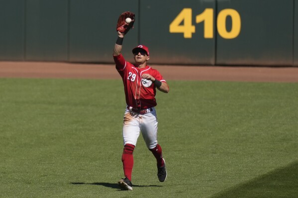 Cincinnati Reds center fielder TJ Friedl catches a fly ball hit by Oakland Athletics Max Schuemann during the second inning of a spring training baseball game on Monday, March 4, 2024, in Goodyear, Ariz. (AP Photo/Carolyn Kaster)