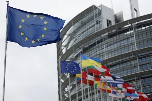 The European flag, left, flies Tuesday, April 18, 2023 at the European Parliament in Strasbourg, eastern France. (AP Photo/Jean-Francois Badias)