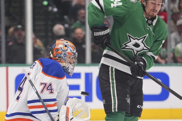 Edmonton Oilers goaltender Stuart Skinner (74) defends the goal against Dallas Stars center Roope Hintz (24) during the first period in Game 2 of the Western Conference finals in the NHL hockey Stanley Cup playoffs Friday, May 23, 2025, in Dallas. (AP Photo/LM Otero)