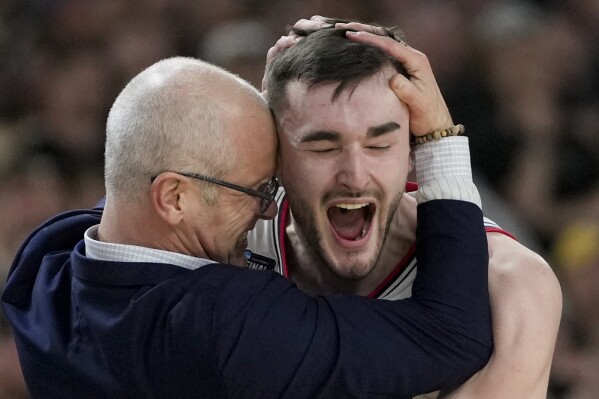 UConn head coach Dan Hurley celebrates with forward Alex Karaban (11) after their win against Purdue in the NCAA college Final Four championship basketball game, Monday, April 8, 2024, in Glendale, Ariz. (AP Photo/David J. Phillip)