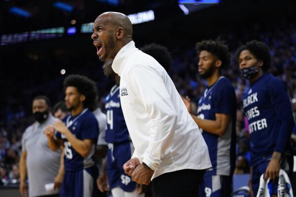 St. Peter's head coach Shaheen Holloway reacts during the first half of a college basketball game against North Carolina in the Elite 8 round of the NCAA tournament, Sunday, March 27, 2022, in Philadelphia. (AP Photo/Chris Szagola)