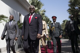 FILE - Sierra Leone President, Ernest Bai Koroma, centre, on arrival for talks with Gambia's President Yahya Jammeh, in Banjul, Gambia, on Dec. 13, 2016. Former President, Ernest Bai Koroma has been charged with treason for his alleged involvement in a failed coup attempt in November, Sierra Leone's government said Wednesday Jan. 3, 2024. (AP Photo/ Sylvain Cherkaoui, File)