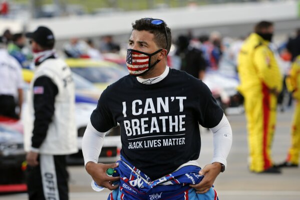 FILE - In this this June 10, 2020, file photo, driver Bubba Wallace wears a Black Lives Matter shirt as he prepares for a NASCAR Cup Series auto race in Martinsville, Va. (AP Photo/Steve Helber, File)