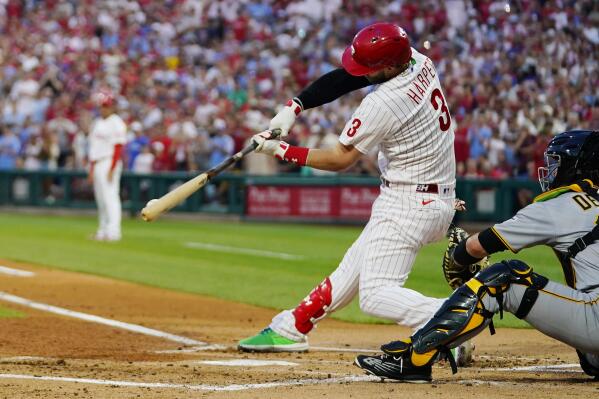 Philadelphia Phillies' Bryce Harper hits a two-run single against Pittsburgh Pirates pitcher Bryse Wilson during the first inning of a baseball game, Friday, Aug. 26, 2022, in Philadelphia. (AP Photo/Matt Slocum)