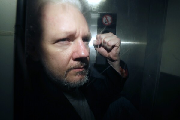 FILE - WikiLeaks founder Julian Assange being taken from court, where he appeared on charges of jumping British bail seven years ago, in London, Wednesday May 1, 2019. A London court is due to rule whether WikiLeaks founder Julian Assange can challenge extradition to the United States on espionage charges. Two judges will issue a ruling Tuesday morning in the High Court on whether Assange can make one final appeal in England. (AP Photo/Matt Dunham, File)
