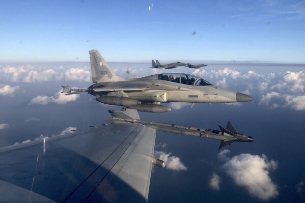 In this handout photo released by the Philippine Air Force, a Philippine Air Force FA-50PH jet fighter, joins the maritime patrol of the Philippines and the United States over Batanes and areas in the West Philippine Sea on Tuesday, Nov. 21, 2023. The United States and Philippines are conducting joint air and maritime patrols in the South China Sea, which come as the two countries step up cooperation in the face of growingly aggressive Chinese activity in the area. (Philippine Air Force via AP)
