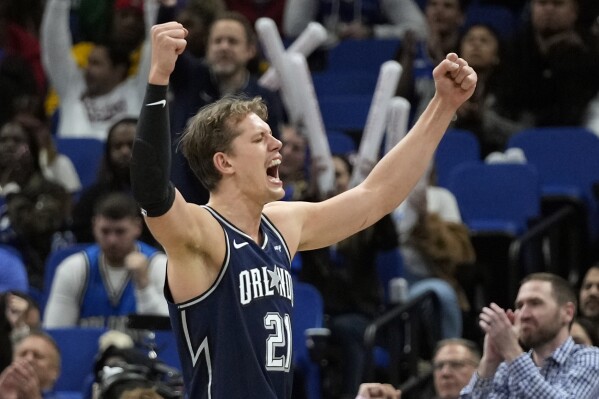 Orlando Magic center Moritz Wagner (21) celebrates after Paolo Banchero made a basket and drew a foul to set up a 3-point play during the second half of the team's NBA basketball game against the Detroit Pistons, Friday, Dec. 8, 2023, in Orlando, Fla. (AP Photo/John Raoux)