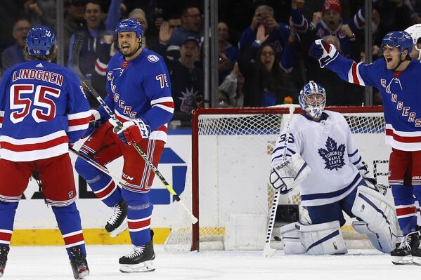New York Rangers' Ryan Reaves (75) celebrates his goal on Toronto Maples Leafs goalie Jack Campbell with Ryan Lindgren (55) during the first period of an NHL hockey game Wednesday, Jan. 19, 2022, in New York. (AP Photo/John Munson)