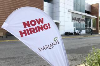 A sign in the parking lot of Mariano's grocery store advertises the availability of jobs Friday, Oct. 8, 2021, in Chicago.  One reason America’s employers are having trouble filling jobs was starkly illustrated in a report Tuesday, Oct. 12: Americans are quitting in droves.  (AP Photo/Charles Rex Arbogast)