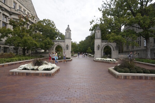 FILE - Students walk to classes on the Indiana University campus, Thursday, Oct. 14, 2021, in Bloomington, Ind. Republican lawmakers in Indiana granted final legislative approval on a bill Thursday, Feb. 29, 2024 that would impose new regulations on tenure for faculty at public colleges and universities. (AP Photo/Darron Cummings, File)