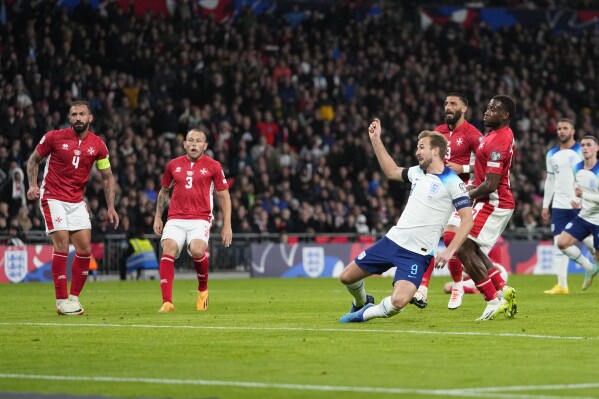 England's Harry Kane, centre left, scores his side's second goal during the Euro 2024 group C qualifying soccer match between England and Malta at Wembley stadium in London, Friday, Nov. 17, 2023. (AP Photo/Kirsty Wigglesworth)