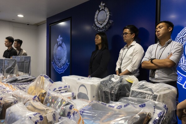 Evidence are displayed by police for media after police arrested six people following allegations of fraud at an unlicensed cryptocurrency exchange in Hong Kong, Tuesday, Sept. 19, 2023. (AP Photo/Louise Delmotte)