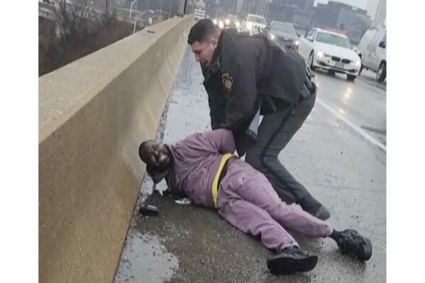 FILE - In this frame grab from cellphone video provided by Celena Morrison, her husband, Darius McLean, is handcuffed by a state trooper during a traffic stop, in Philadelphia, March 2, 2024. The state trooper is no longer employed by the Pennsylvania state police, officials said Friday, May 10, 2024. (Celena Morrison via AP, File)