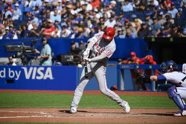 Los Angeles Angels designated hitter Shohei Ohtani (17) hits a two-run home run during the seventh inning of a baseball game against the Toronto Blue Jays, in Toronto, Sunday, Aug. 28, 2022. (Christopher Katsarov/The Canadian Press via AP)