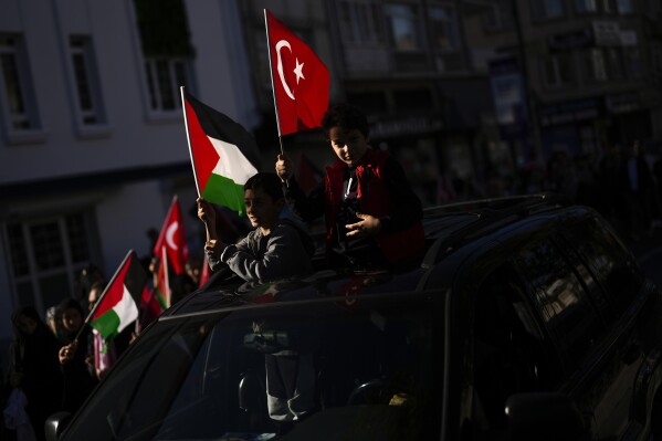 FILE - Two youngsters wave a Palestinian and a Turkish flags during a pro Palestinians protest in Istanbul, Turkey on Nov. 12, 2023. (AP Photo/Francisco Seco, File)