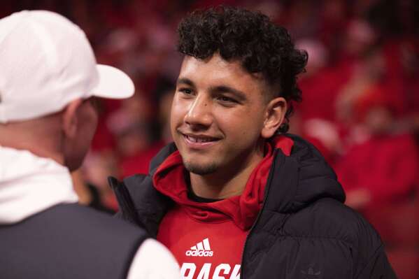 FILE - Dylan Raiola chats with supporters courtside before an NCAA college basketball game between Nebraska and Indiana, Wednesday, Jan. 3, 2024, in Lincoln, Neb. (AP Photo/Rebecca S. Gratz, File)