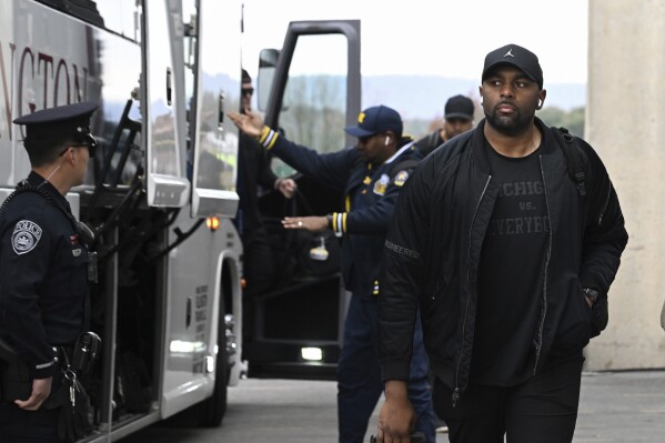 Michigan offensive coordinator Sherrone Moore arrives for an NCAA college football game against Penn State, Saturday, Nov. 11, 2023, in State College, Pa. (AP Photo/Barry Reeger)