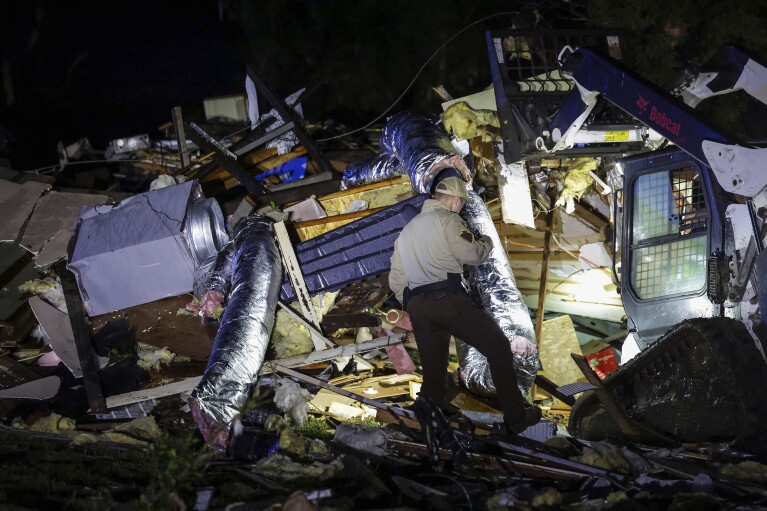 Oklahoma Highway Patrol troopers search for storm damage in Barnsdall, Okla., Tuesday, May 7, 2024. (Mike Simmons/Tulsa World via AP)