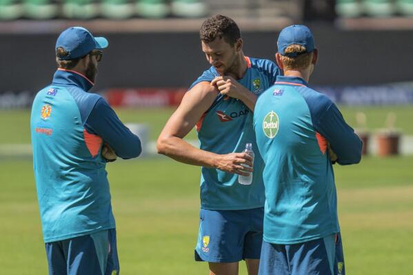 Australia's Josh Hazlewood, center, flexes his muscles as he interacts with team support staff during a training session ahead of their first cricket test match against India, in Nagpur, India, Wednesday, Feb. 8, 2023. (AP Photo/Rafiq Maqbool)