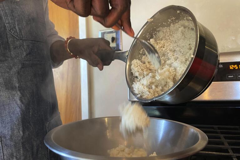 Pierre Thiam, executive chef and co-founder of New York-based fine-casual food chain Teranga, cooks fonio, a variety of millet in El Cerrito, Calif., Friday, Jan. 27, 2023. “Fonio is nicknamed the Lazy Farmers crop. That’s how easy it is to grow," Thiam said. (AP Photo/Haven Daley)