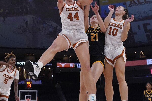 Texas forward Taylor Jones (44) grabs a rebound over Long Beach State forward Abby Shoff (21) during the second half of an NCAA college basketball game in Austin, Texas, Wednesday, Dec. 6, 2023. (AP Photo/Eric Gay)