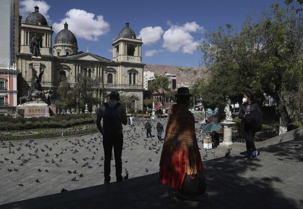People gather in Plaza Murillo, the main square in downtown La Paz, Bolivia, Monday, Oct. 19, 2020, the morning after general elections. Results trickled in from Bolivia's presidential election, a high-stakes redo of last year's annulled ballot that saw president Evo Morales resign and flee the country. (AP Photo/Martin Mejia)