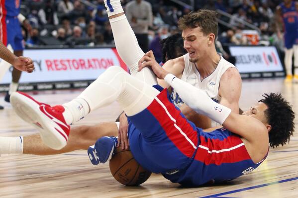 Orlando Magic forward Franz Wagner, top, and Detroit Pistons guard Cade Cunningham scramble for the ball during the first half of an NBA basketball game Saturday, Oct. 30, 2021, in Detroit. (AP Photo/Duane Burleson)
