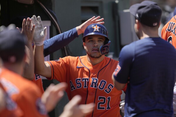 Houston Astros' Yainer Diaz (21) is congratulated by teammates after hitting a home run against the Oakland Athletics during the fifth inning of a baseball game in Oakland, Calif., Sunday, July 23, 2023. (AP Photo/Jeff Chiu)