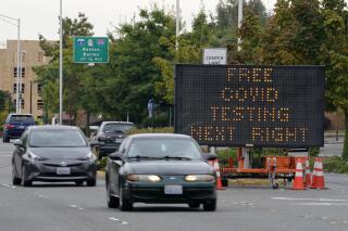 A sign directs motorists to a COVID-19 testing site, Wednesday, Sept. 22, 2021, in Tukwila, Wash., south of Seattle. (AP Photo/Ted S. Warren)