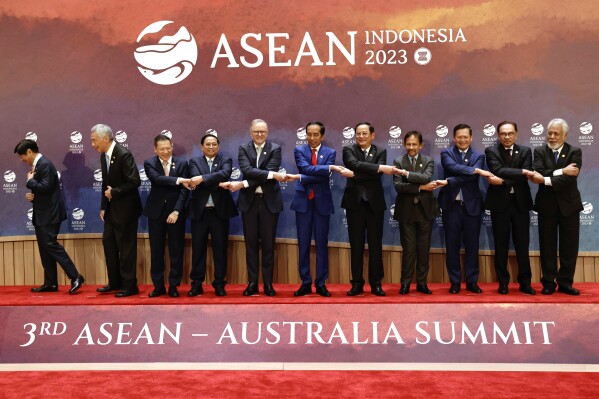 FILE - From left to right, Philippine's President Ferdinand Marcos Jr., Singapore's Prime Minister Lee Hsien Loong, head of Thailand's delegation Sarun Charoensuwan, Vietnam's Prime Minister Pham Minh Chinh, Australian Prime Minister Anthony Albanese, Indonesian President Joko Widodo, Laos' Prime Minister Sonexay Siphandone, Brunei's Sultan Hassanal Bolkiah, Cambodia's Prime Minister Hun Manet, Malaysian Prime Minister Anwar Ibrahim, and East Timor's Prime Minister Xanana Gusmao hold hands as they pose for a family photo during the Association of Southeast Asian Nations (ASEAN)-Australia Summit, in Jakarta, Indonesia, Thursday, Sept. 7, 2023. The ASEAN-Australia Special Summit that starts in Melbourne on Monday, March 4, 2024, marks 50 years since Australia became the first official partner of the Asian bloc. (Willy Kurniawan/Pool Photo via AP, File)