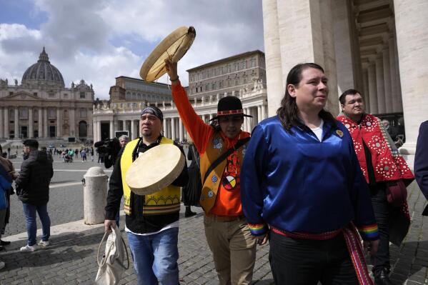 FILE - Indigenous artists from across Canada walk in St. Peter's Square, at the Vatican, Friday, April 1, 2022. Pope Francis, struggling with a bad knee, is going ahead with his plan to visit Canada this summer so he can apologize in person for abuse suffered by Indigenous peoples at the hands of the Catholic church. The Vatican on Friday, May 13, 2022 announced that Francis will head to Canada on July 24, returning to Rome on July 30. (AP Photo/Alessandra Tarantino, File)