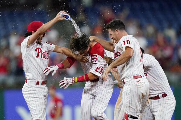 Philadelphia Phillies' Nick Maton, center, celebrates with teammates after hitting a game-winning RBI-single against Cincinnati Reds pitcher Alexis Diaz during the ninth inning of a baseball game, Tuesday, Aug. 23, 2022, in Philadelphia. (AP Photo/Matt Slocum)