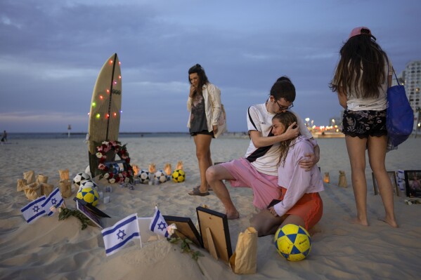 FILE - Friends of those killed during Hamas' Oct. 7 attack on the Nova Music Festival in southern Israel staged a vigil in memory of the victims at the beach in Tel Aviv, Israel on Nov. 11, 2023. (AP Photo/Oded Balilty)
