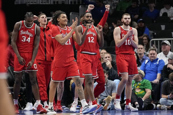 Ohio State players celebrate a win after an NCAA college basketball game against UCLA, Saturday, Dec. 16, 2023, in Atlanta, Ga. (AP Photo/Brynn Anderson)