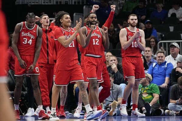 Ohio State players celebrate a win after an NCAA college basketball game against UCLA, Saturday, Dec. 16, 2023, in Atlanta, Ga. (AP Photo/Brynn Anderson)