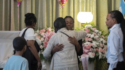 CAPTION CORRECTION CORRECTS NAME SPELLING: Mabel Alvarez Benedicks, mother of Anadith Danay Reyes Alvarez, center, greets a guest during the wake at R.G. Ortiz Funeral Home on Friday, June 16, 2023, in New York. Dozens of people are remembering the 8-year-old girl who died in Border Patrol custody. (AP Photo/Jeenah Moon)