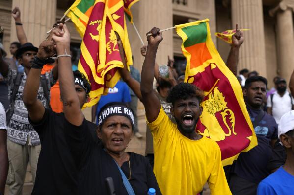 Protesters shout slogans demanding elected president Ranil Wickremesinghe step down during a protest at the presidential secretariat premise in Colombo, Sri Lanka, Wednesday, July 20, 2022. Sri Lanka's prime minister was elected president Wednesday by lawmakers who opted for a seasoned, veteran leader to lead the country out of economic collapse, despite widespread public opposition.(AP Photo/Rafiq Maqbool)