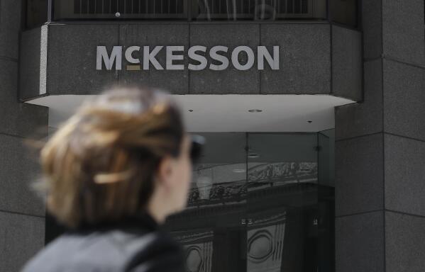 FILE - In this July 17, 2019, file photo, a pedestrian passes a McKesson sign on an office building in San Francisco. Native American tribes in the U.S. have reached settlements worth $590 million over opioids. A court filing made Tuesday, Feb. 1, 2022 in Cleveland lays out the details of the settlements with drugmaker Johnson & Johnson and distribution companies AmerisoruceBergen, Cardinal Health and McKesson. (AP Photo/Jeff Chiu, File)